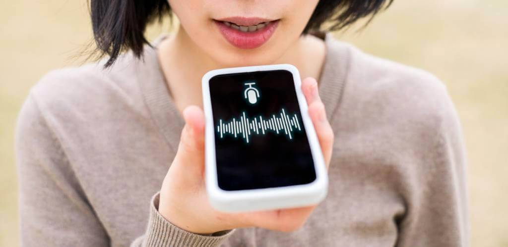 person holding smartphone and using voice search