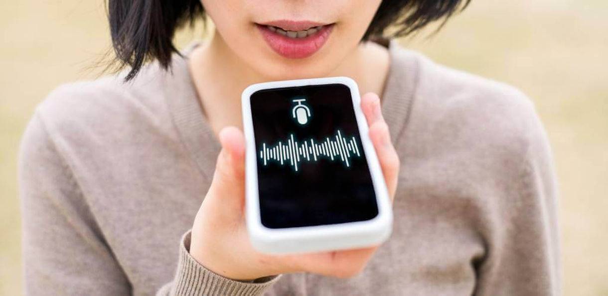 person speaking voice search to mobile smartphone assistant