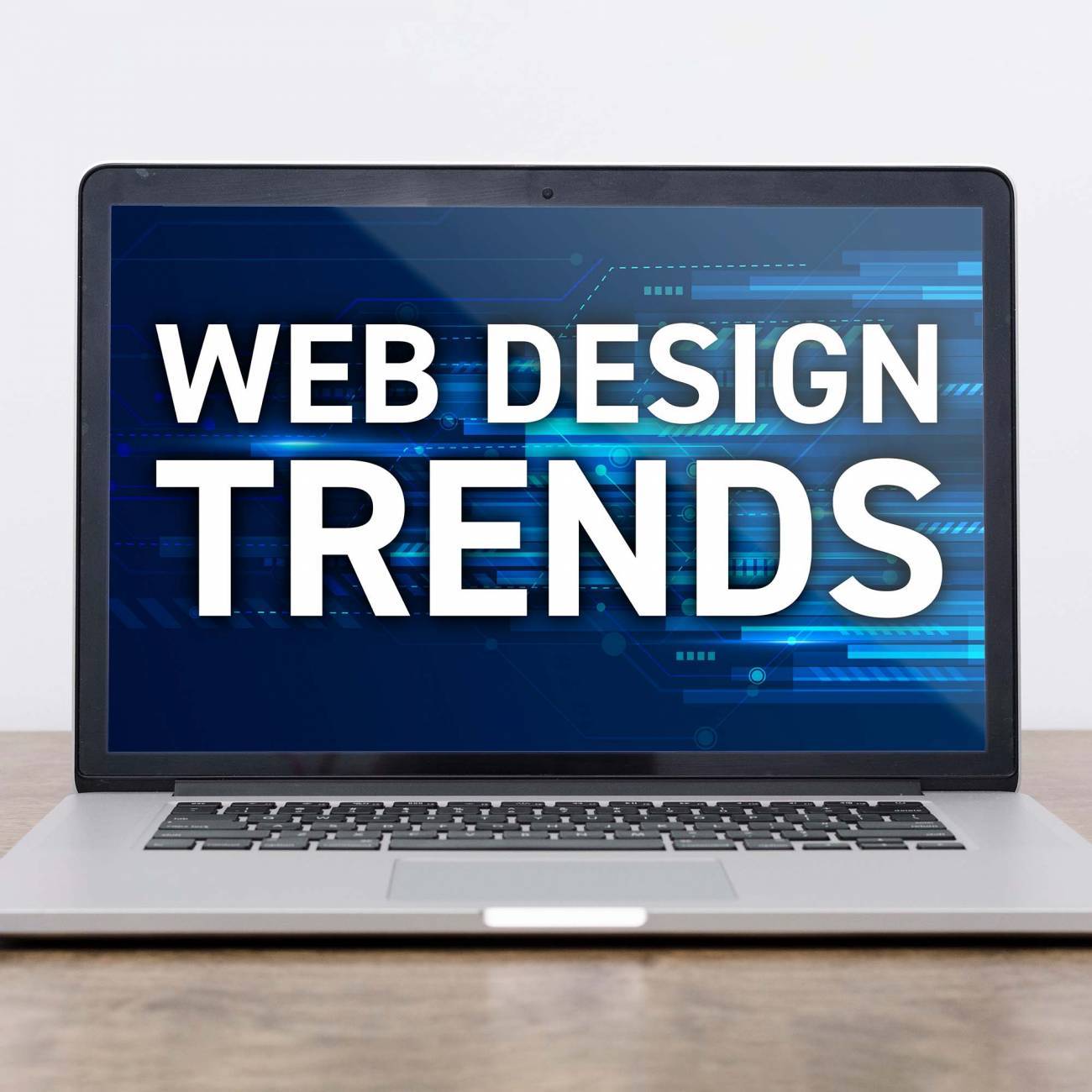 a laptop with web design trends displaying on the screen